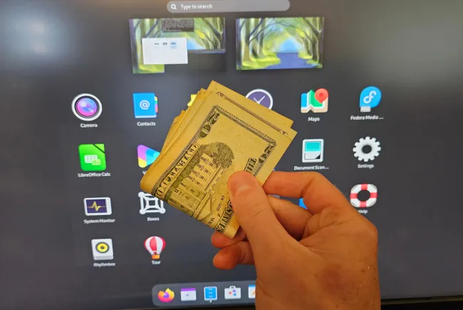US dollars in front of GNOME desktop
